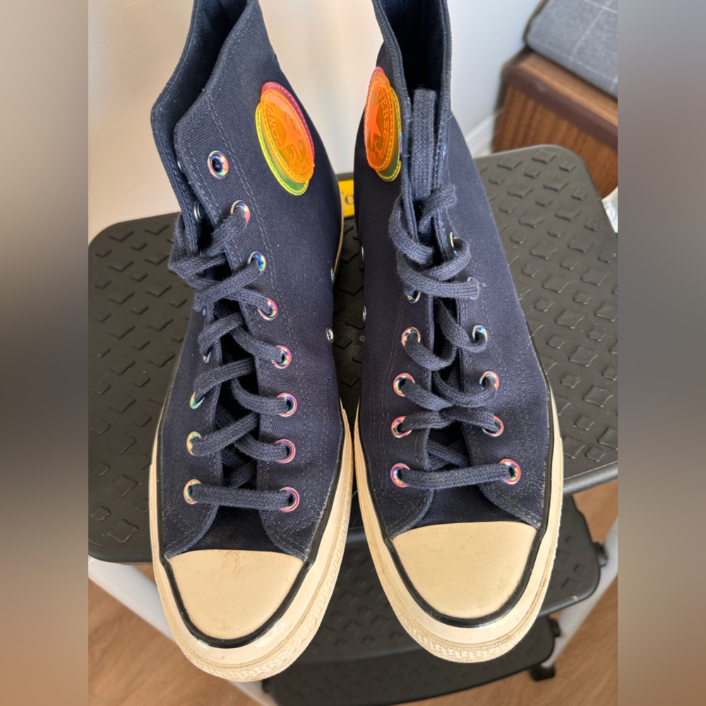 Navy canvas All Stars high tops with neon patches.